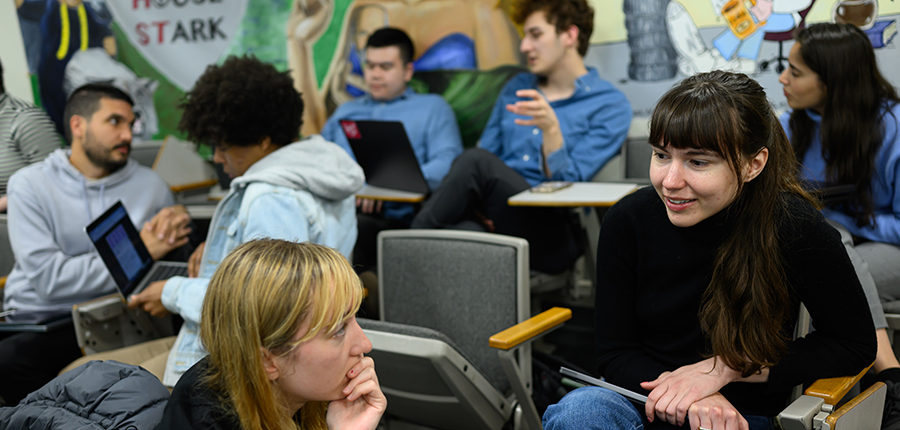 Photo of students in seats discussing 