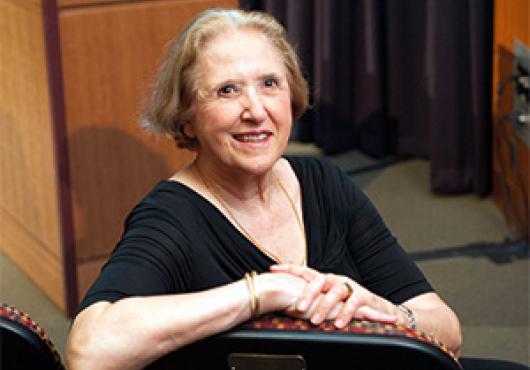 Anne Rassiga sitting in the Veritas Science Center
