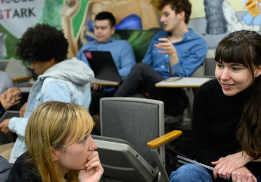Photo of students in seats discussing 