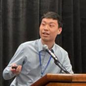 Man speaking at a podium.